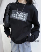 Black crewneck sweatshirt with square number logo worn by model