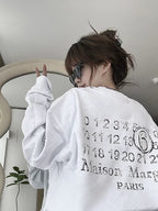 White crewneck sweatshirt worn, back numbers and Maison Margiela PARIS graphic