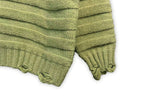 Bright green knit sweater cuffs with ribbed trim and frayed knit edges