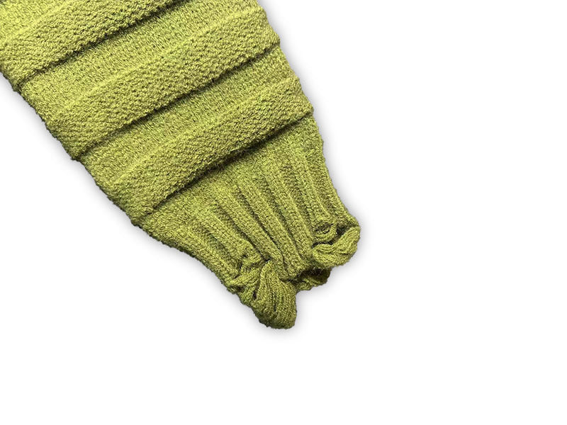 Bright green knit sweater sleeve cuff with ribbed trim and small knit frays