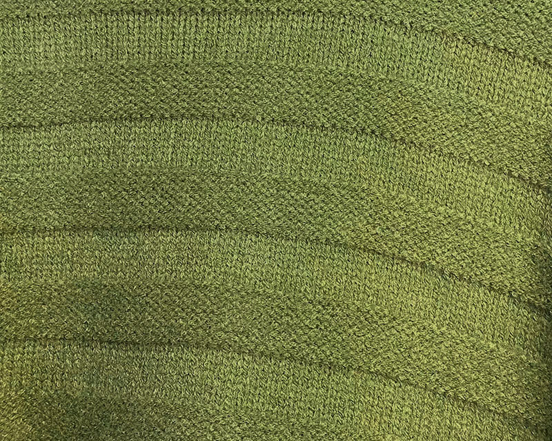 Olive green knit fabric close-up with fine textured weave