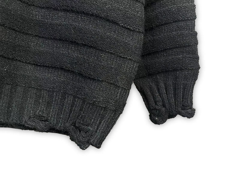 Dark charcoal knit sweater sleeve with ribbed cuff and hem