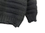 Dark charcoal knit sweater sleeve with ribbed cuff and hem