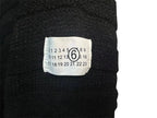 Dark charcoal knit sweater with size label on front