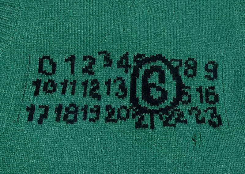 Green knit sweater vest with black graphic logo print