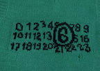 Green knit sweater vest with black graphic logo print