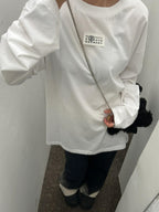 White long-sleeve crewneck T-shirt with small front logo label