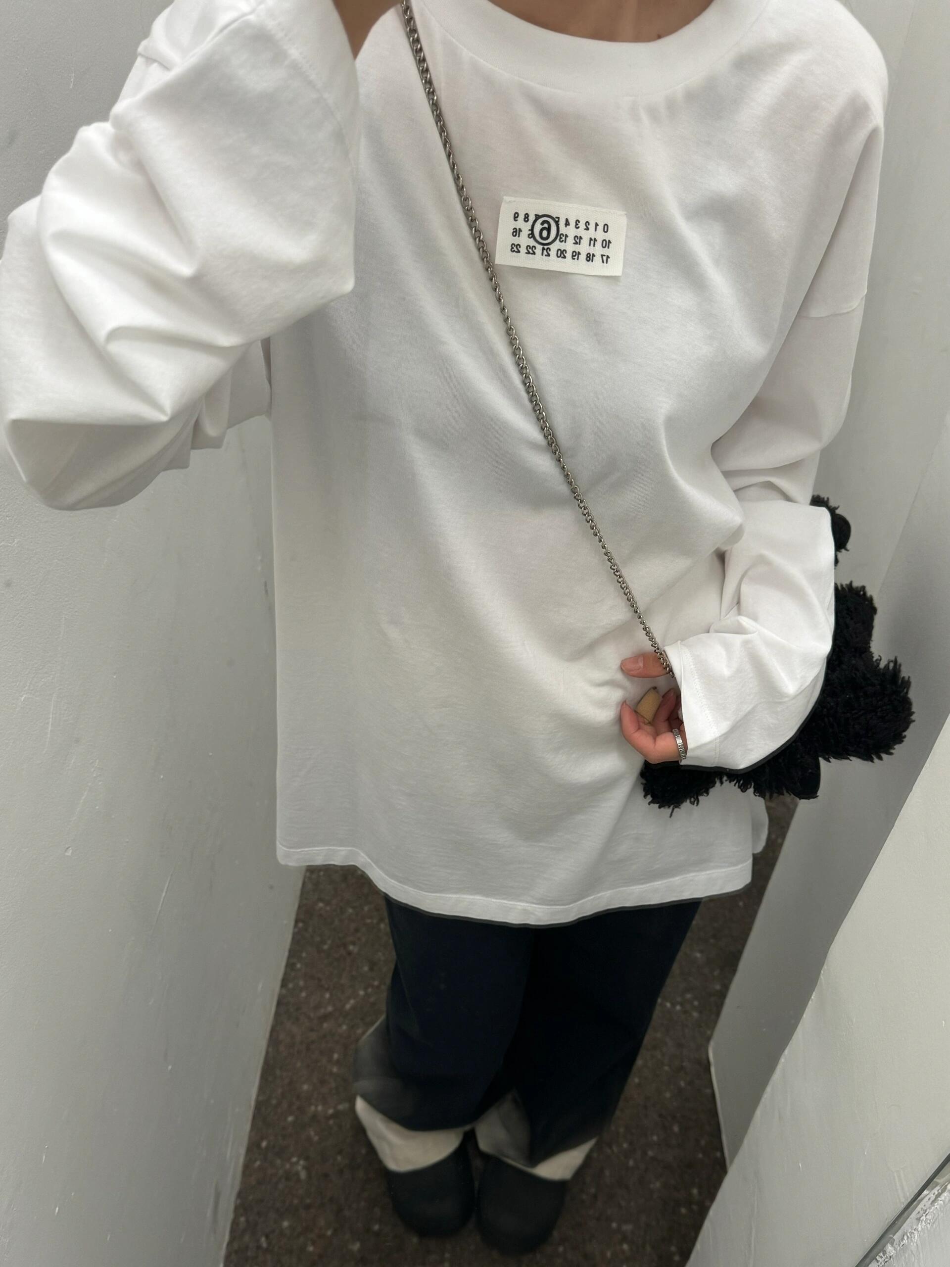 White long-sleeve crewneck T-shirt with small front logo label