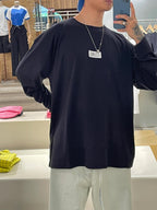 Dark long-sleeve crewneck T-shirt with front logo label