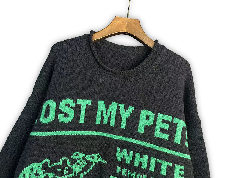 Dark crewneck sweatshirt close-up with “LOST MY PET” and “WHITE/BLACK” graphic