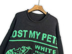 Dark crewneck sweatshirt close-up with “LOST MY PET” and “WHITE/BLACK” graphic