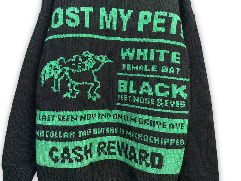 Dark crewneck sweatshirt close-up with “LOST MY PET” and “CASH REWARD” print