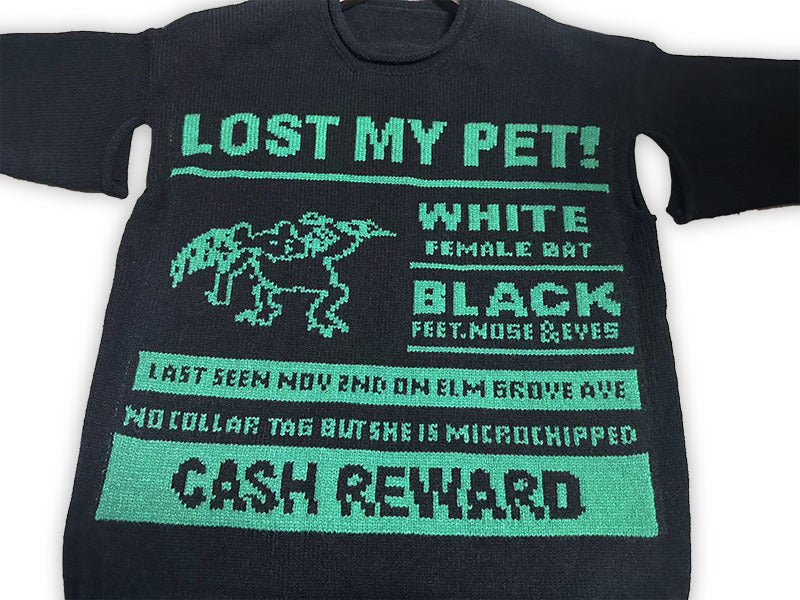 Dark sweatshirt with “LOST MY PET” graphic, white/black text, and cash reward panel