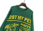 Green knit sweater with crew neck and “LOST MY PET?” print