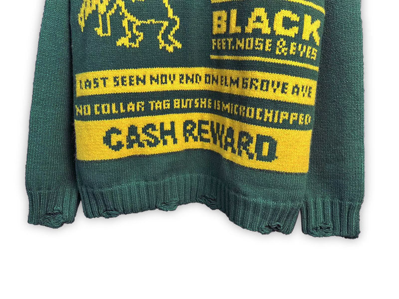 Green knit sweater with graphic text panel and ribbed cuffs