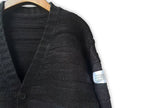 Maison Margiela dark cardigan close-up on shoulder and sleeve with small tag label