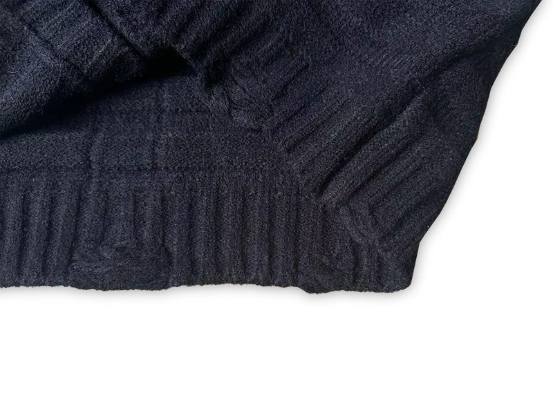 Maison Margiela dark knit cardigan close-up of ribbed cuff and side knit texture