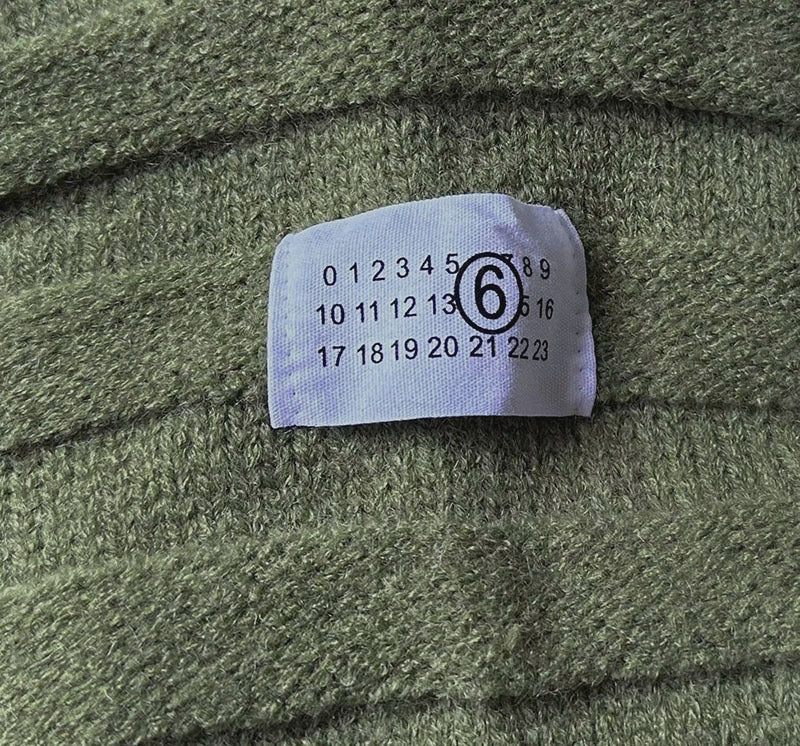 Olive green knit fabric with size label sewn near the chest