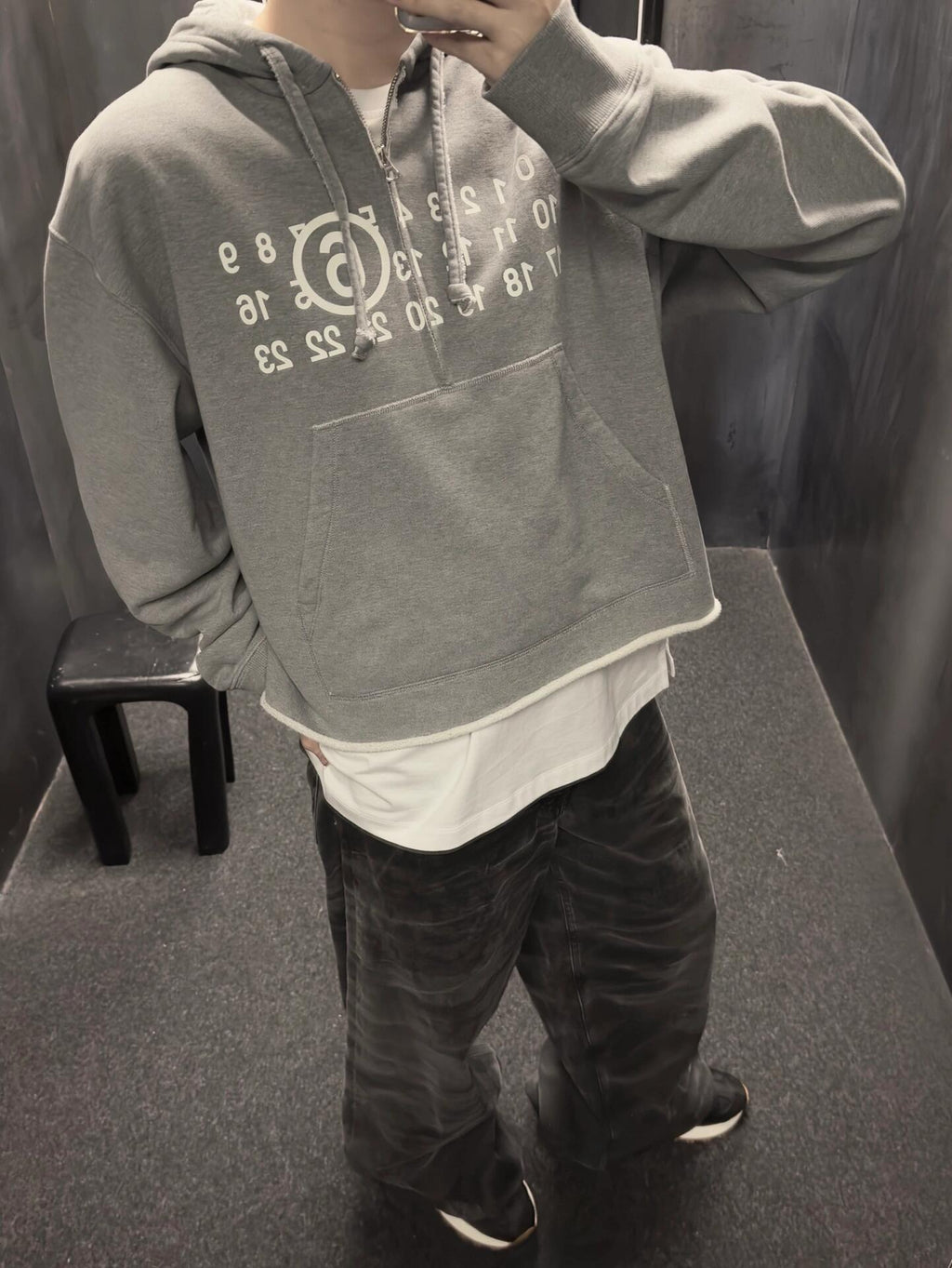 Heather grey MM6 Maison Margiela hooded sweatshirt with number print, worn by model