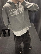 Heather grey MM6 Maison Margiela hooded sweatshirt with number print, worn by model