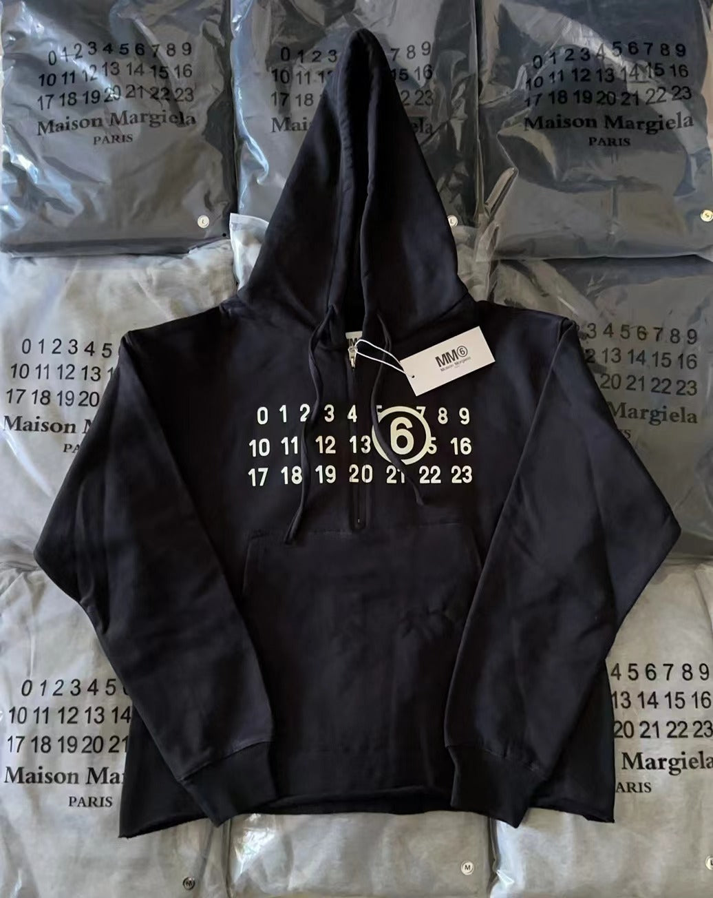 Black Maison Margiela hoodie with drawstring hood and front logo print