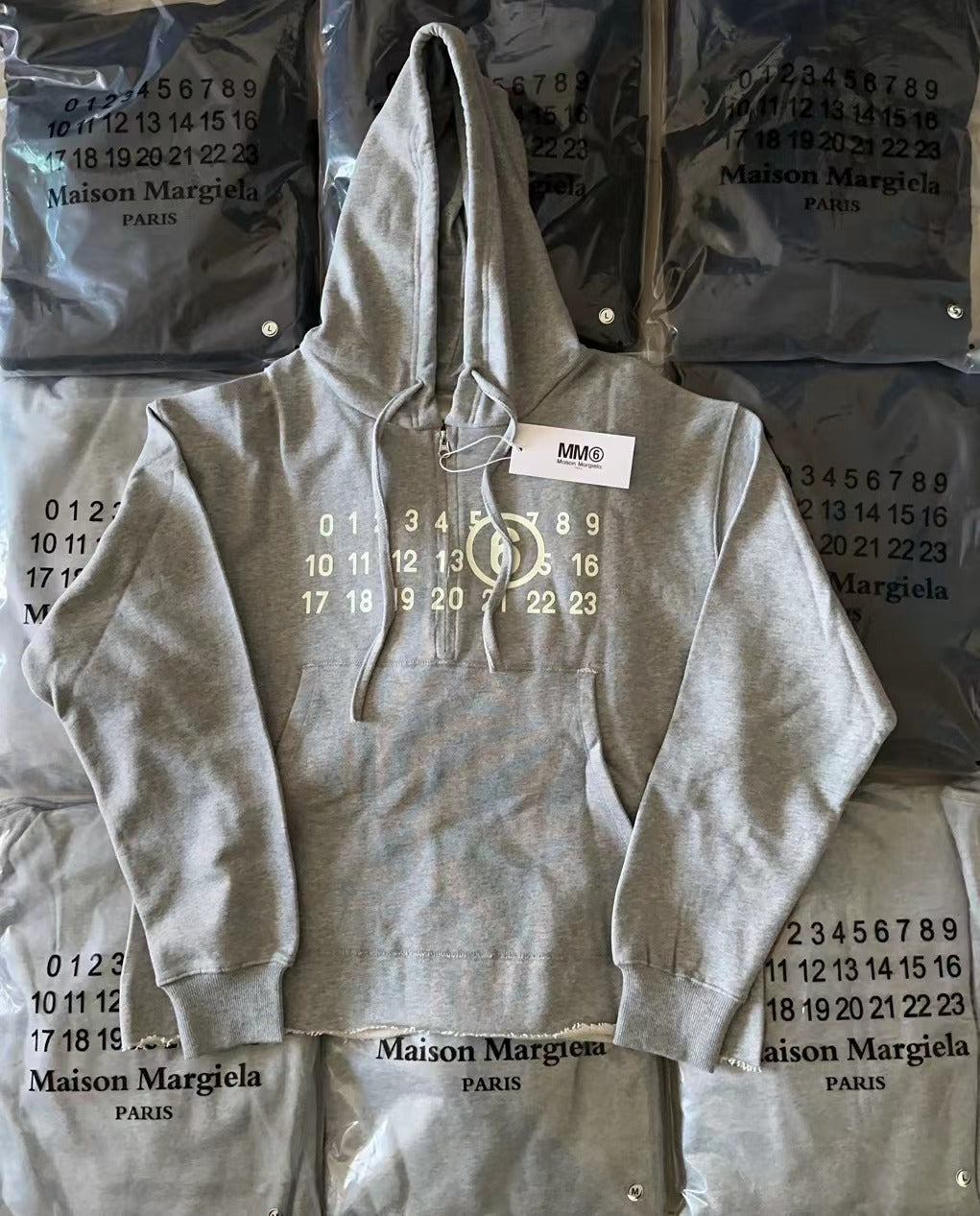 Gray Maison Margiela hoodie with drawstring hood and front logo print