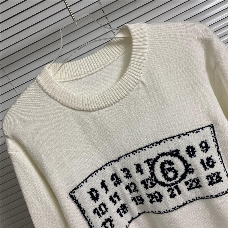 Cream crewneck sweater close-up of number graphic patch across the chest