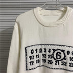 Cream crewneck knit sweater with ribbed collar and number graphic panel