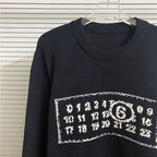 Navy knit sweater with ribbed crew neck and white graphic number logo across chest