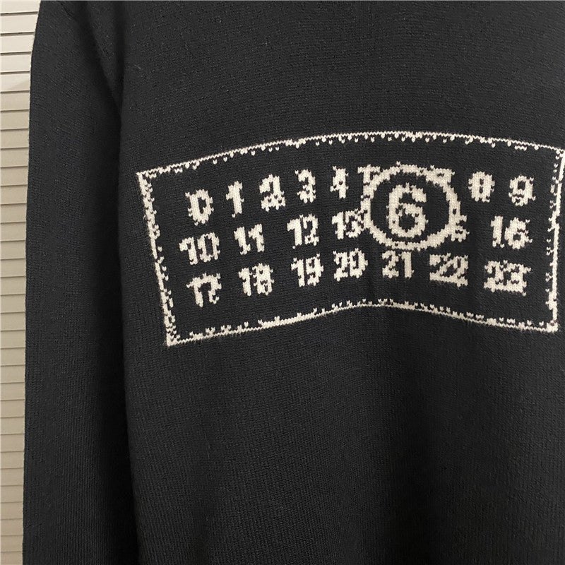 Navy knit sweater close-up: white rectangular number graphic print on chest