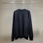 Navy knit sweater on hanger with ribbed crew neck, long sleeves, and relaxed fit