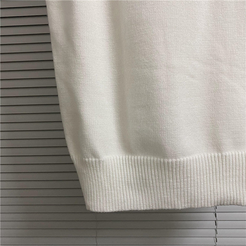 Cream sleeveless knit vest with ribbed hem and waistband