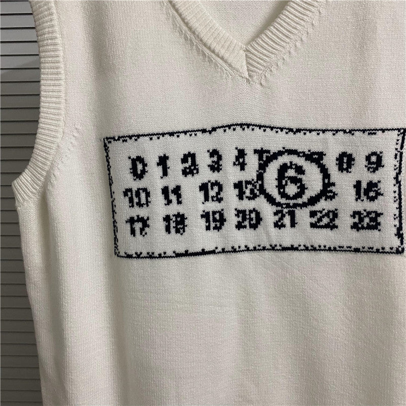 Cream knit vest close-up of number and symbol patch on chest