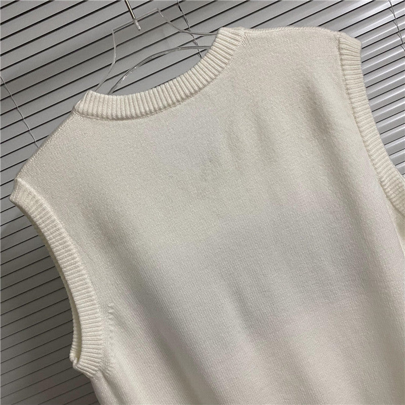 Cream sleeveless knit vest back view with ribbed collar and hem