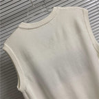 Cream sleeveless knit vest back view with ribbed collar and hem