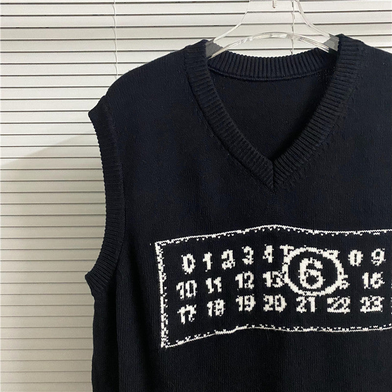 Dark sleeveless V-neck knit top with ribbed trim and rectangular graphic patch