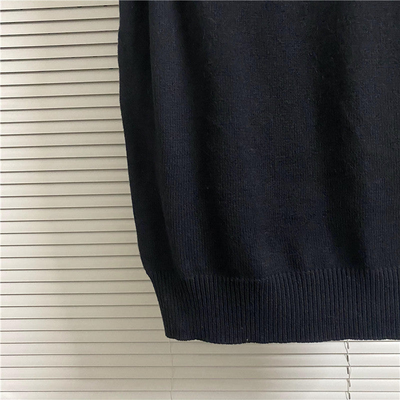 Dark sleeveless knit top with V-neck and ribbed hem