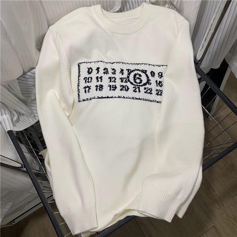 Cream knit sweater with ribbed crew neck and black/blue number graphic chest patch