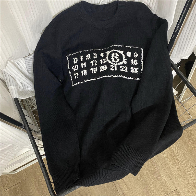 Black knit sweater with ribbed crew neck and white number logo graphic on chest
