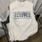 White sleeveless V-neck knit top with rectangular graphic patch