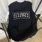 Black sleeveless V-neck knit top with rectangular graphic patch and emblem