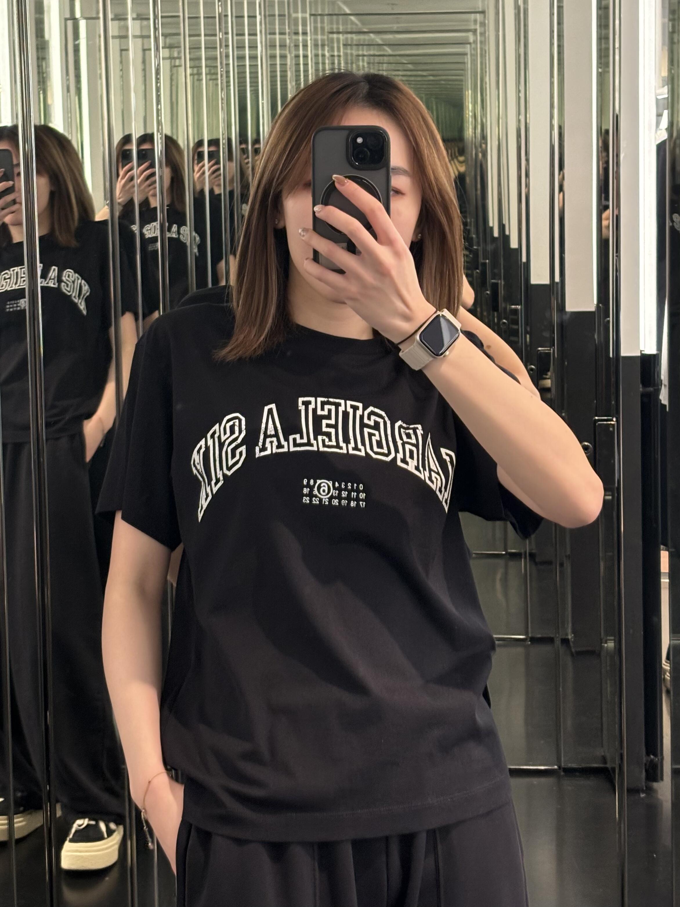Black crewneck T-shirt with Maison Margiela logo and graphic print