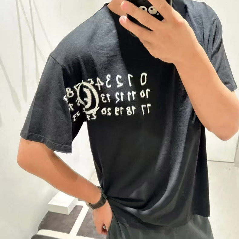 Black graphic T-shirt on model, crew neck, short sleeves