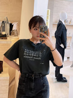Black T-shirt on model with graphic numbers and “PARIS” chest print