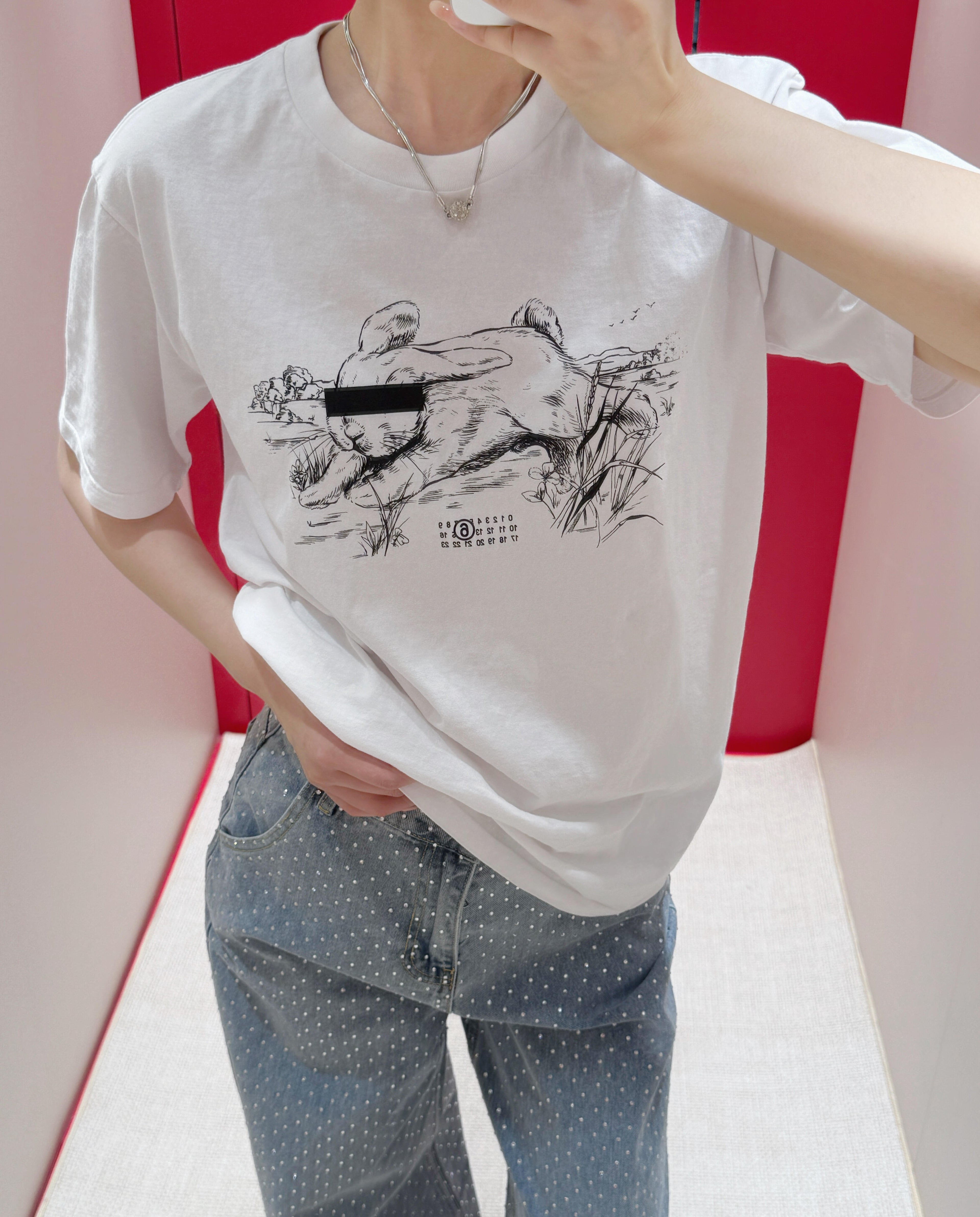 Maison Margiela white T-shirt with animal graphic print worn by a person