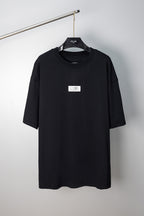 Black T-shirt with crew neck and small front logo label, short sleeves
