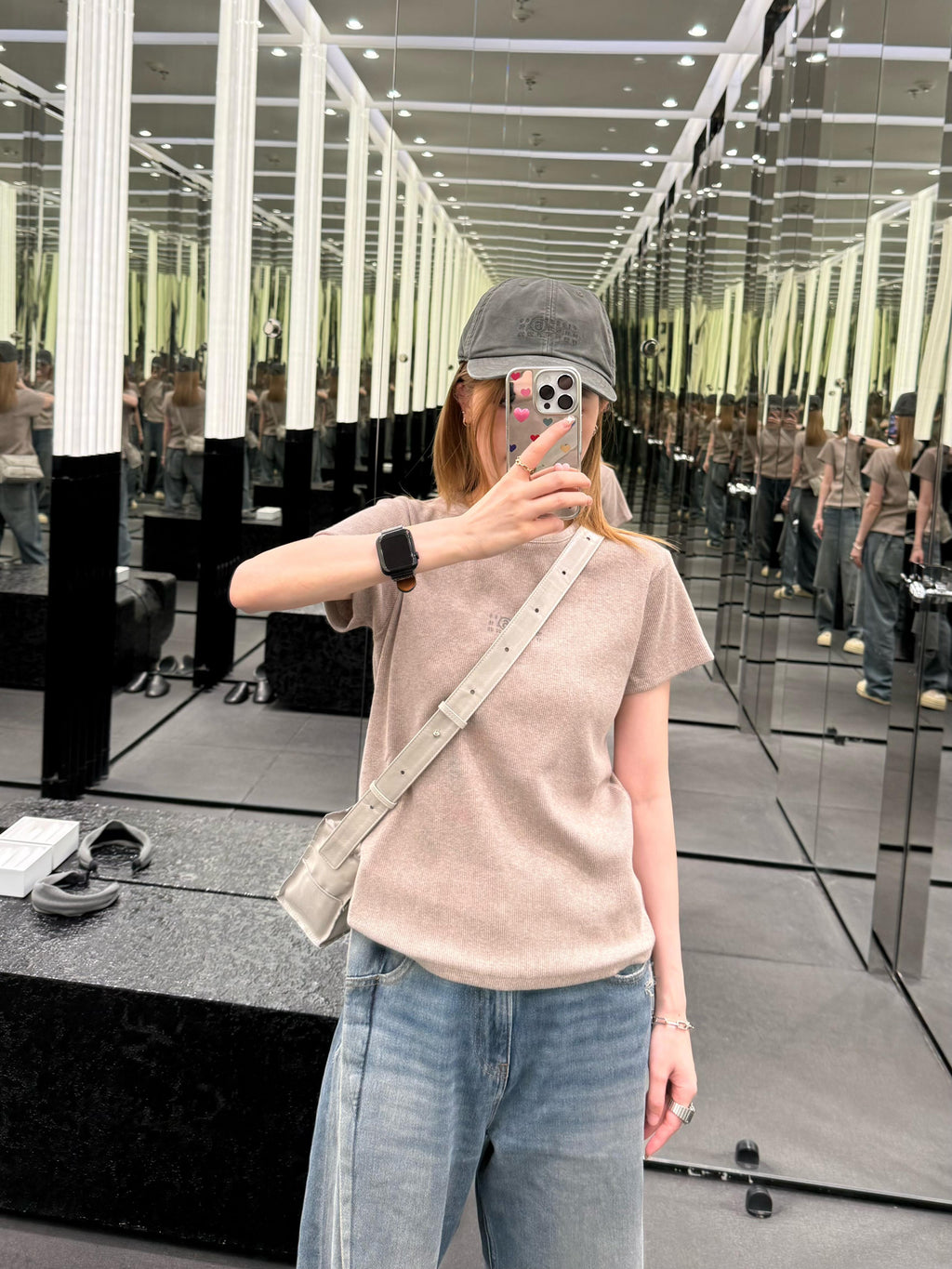 Beige crew-neck T-shirt with small chest logo, worn by model