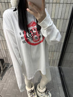 White long-sleeve T-shirt with red emblem graphic, worn by model