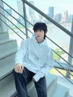 Maison Margiela pullover hoodie in light blue, worn with hood and front logo print.