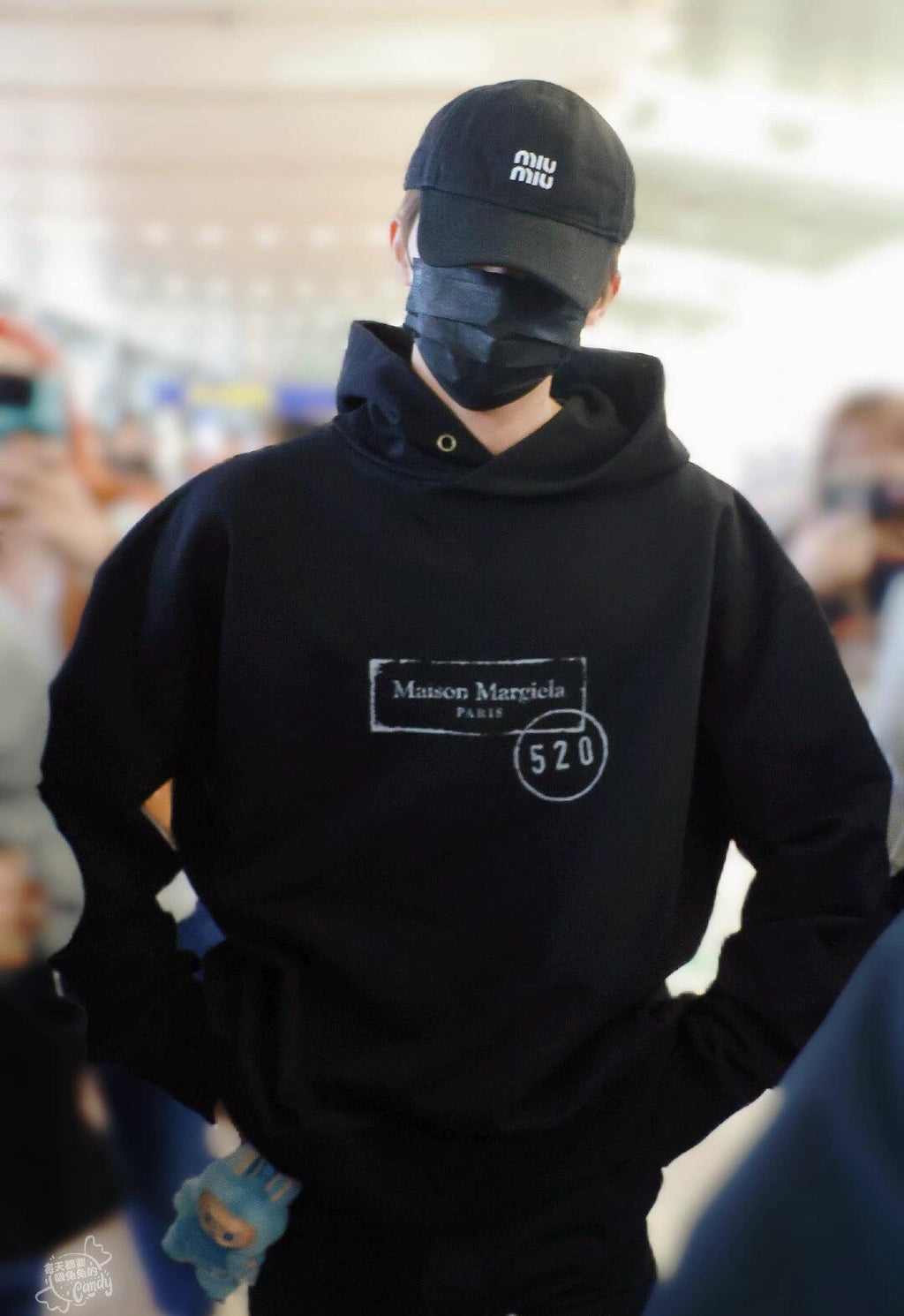 Maison Margiela pullover hoodie in black, hood up with front logo patch.